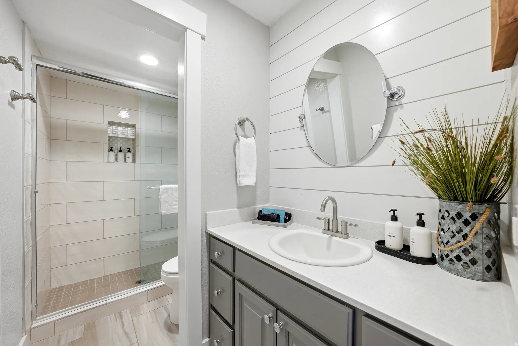 Full bathroom featuring vanity, a stall shower, and recessed lighting