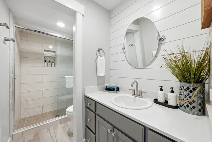 Full bathroom featuring vanity, a stall shower, and recessed lighting