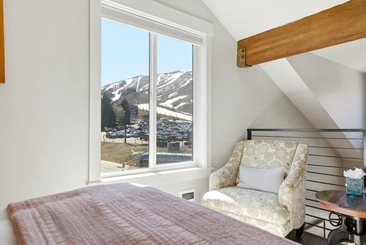 Bedroom with a mountain view and lofted ceiling