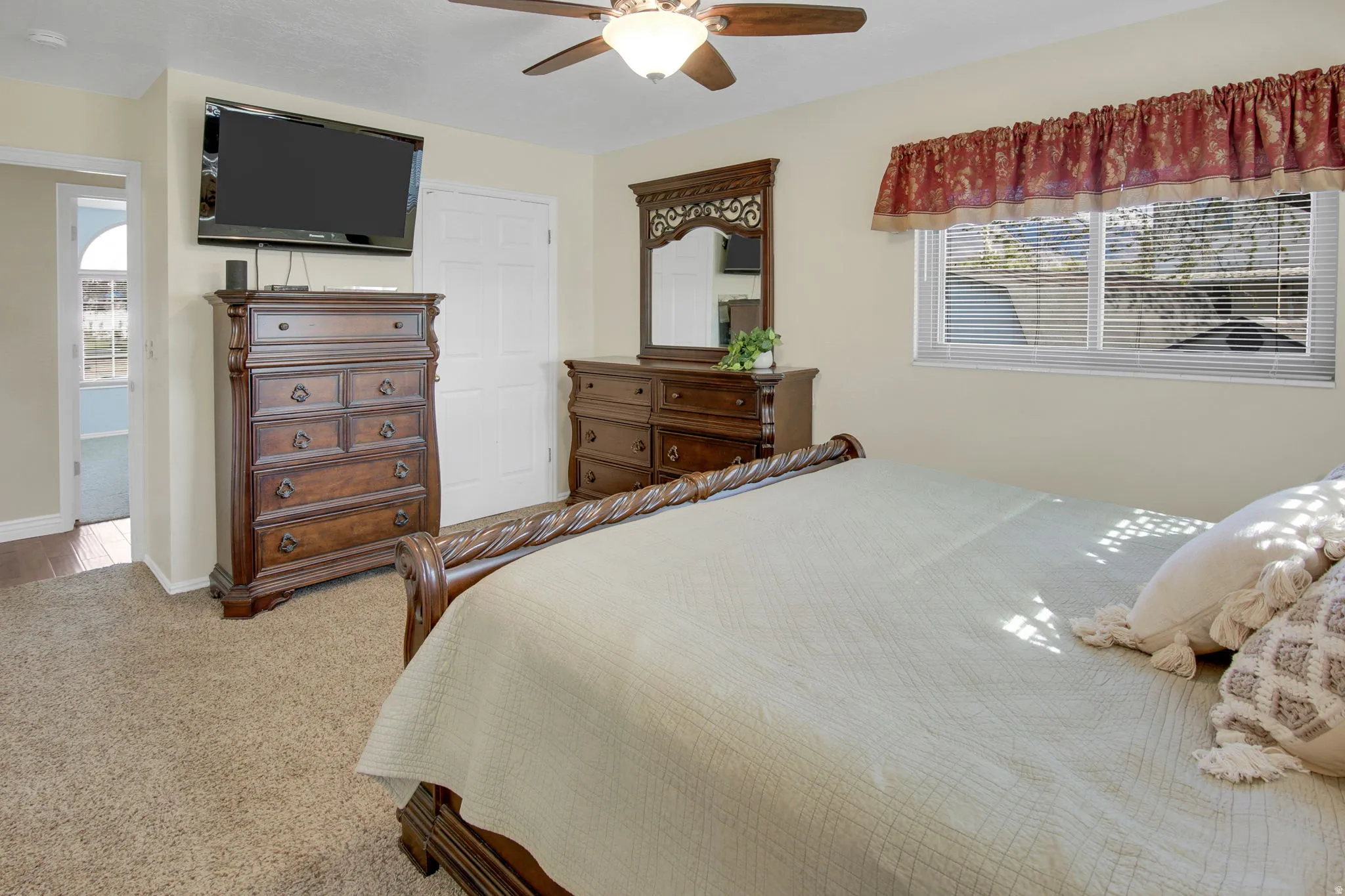 Bedroom featuring light carpet and ceiling fan