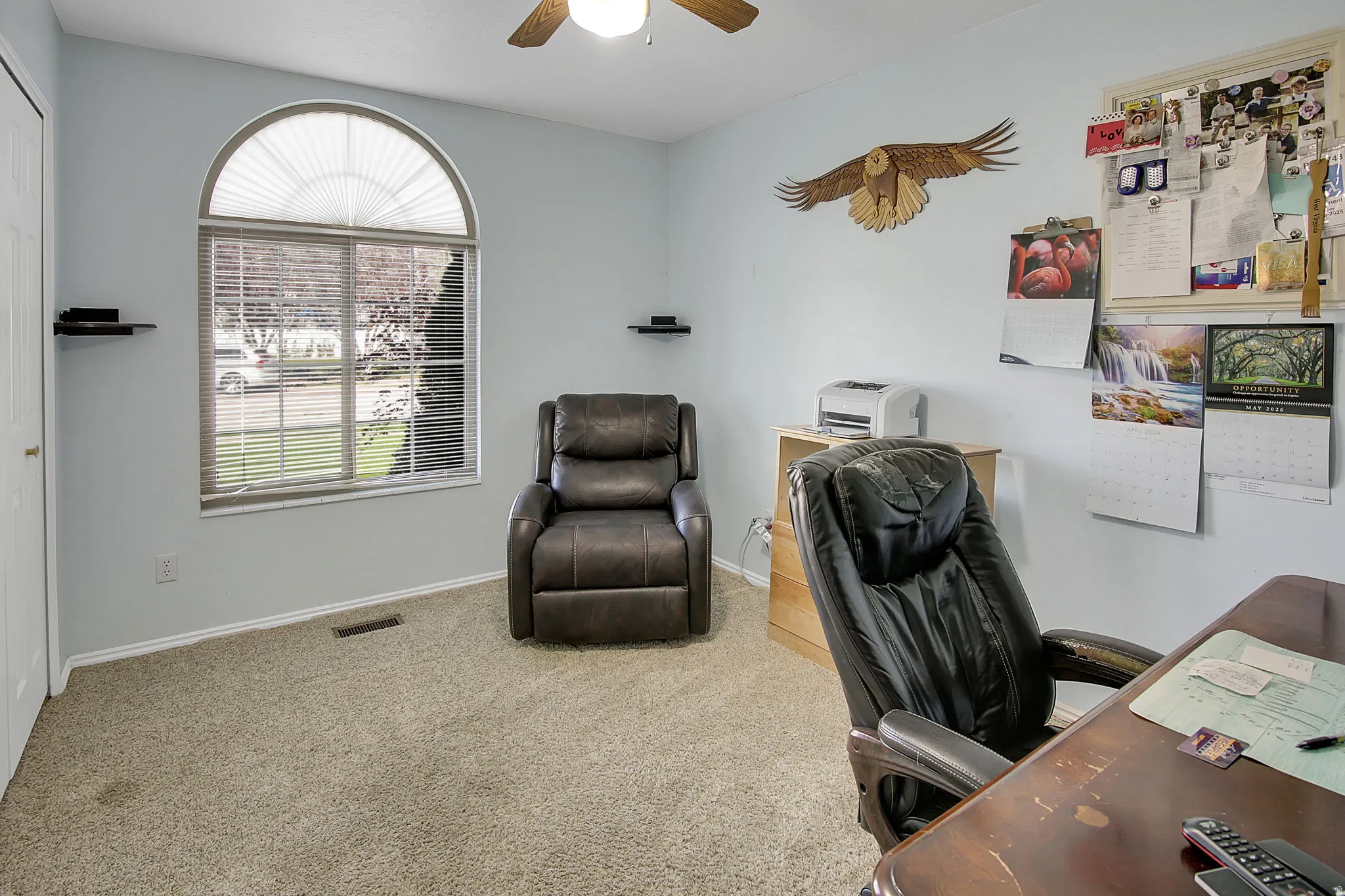 Office space with carpet floors and ceiling fan