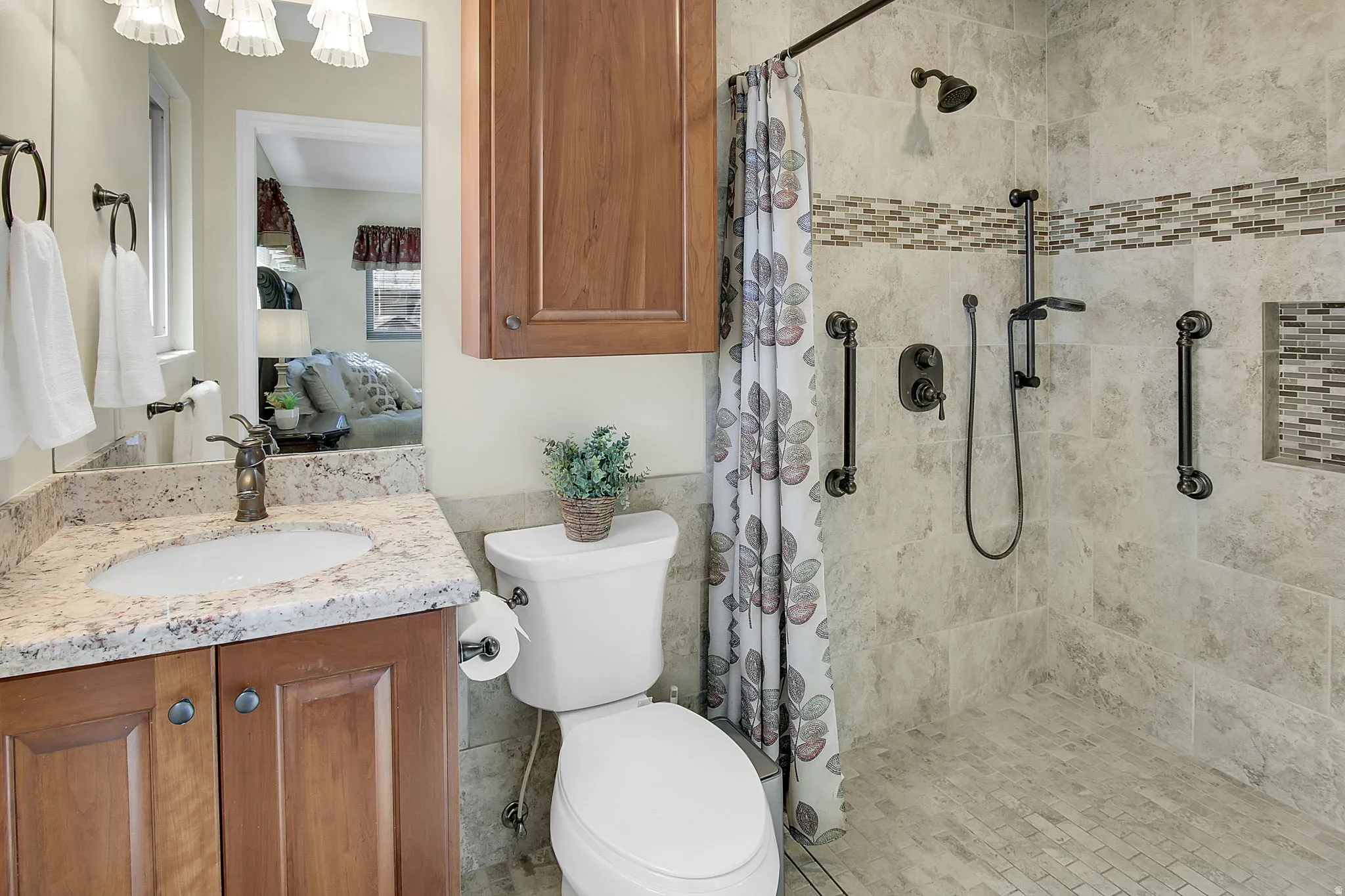 Bathroom featuring ensuite bath, vanity, and a shower stall