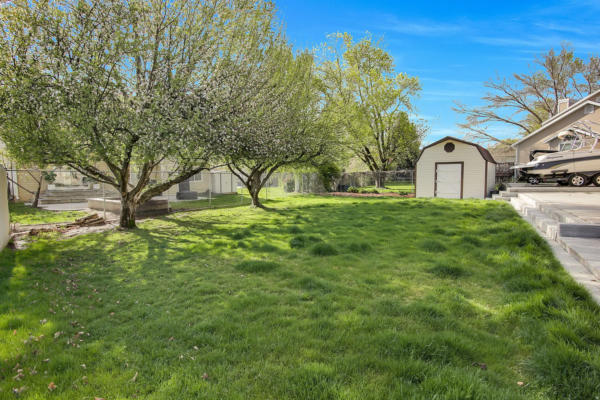 Fenced backyard with a storage unit