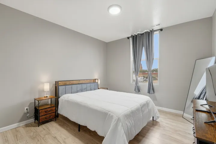 Bedroom featuring light wood-style floors and baseboards