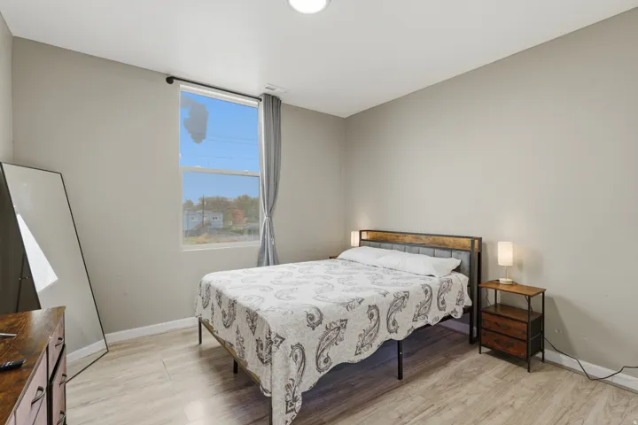 Bedroom with light wood-style flooring and baseboards
