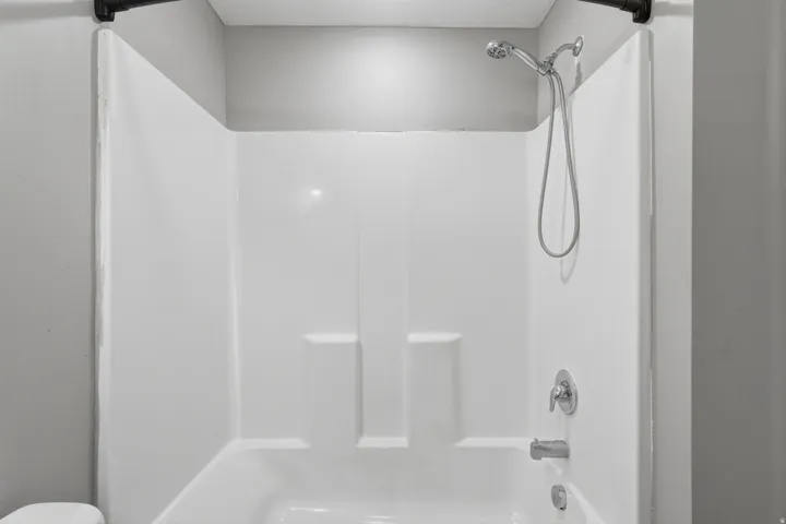 Full bathroom featuring  shower combination and toilet