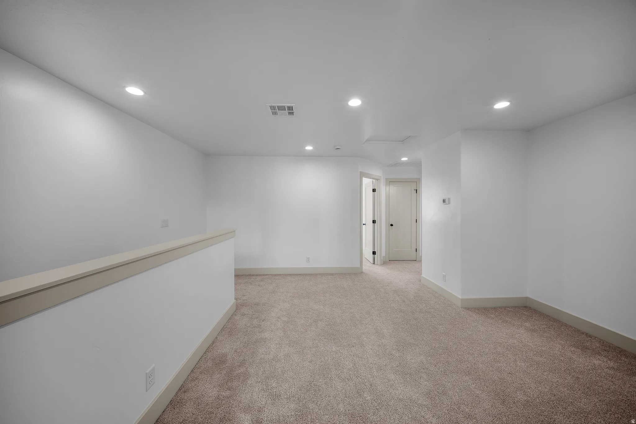 Unfurnished room featuring recessed lighting and light carpet