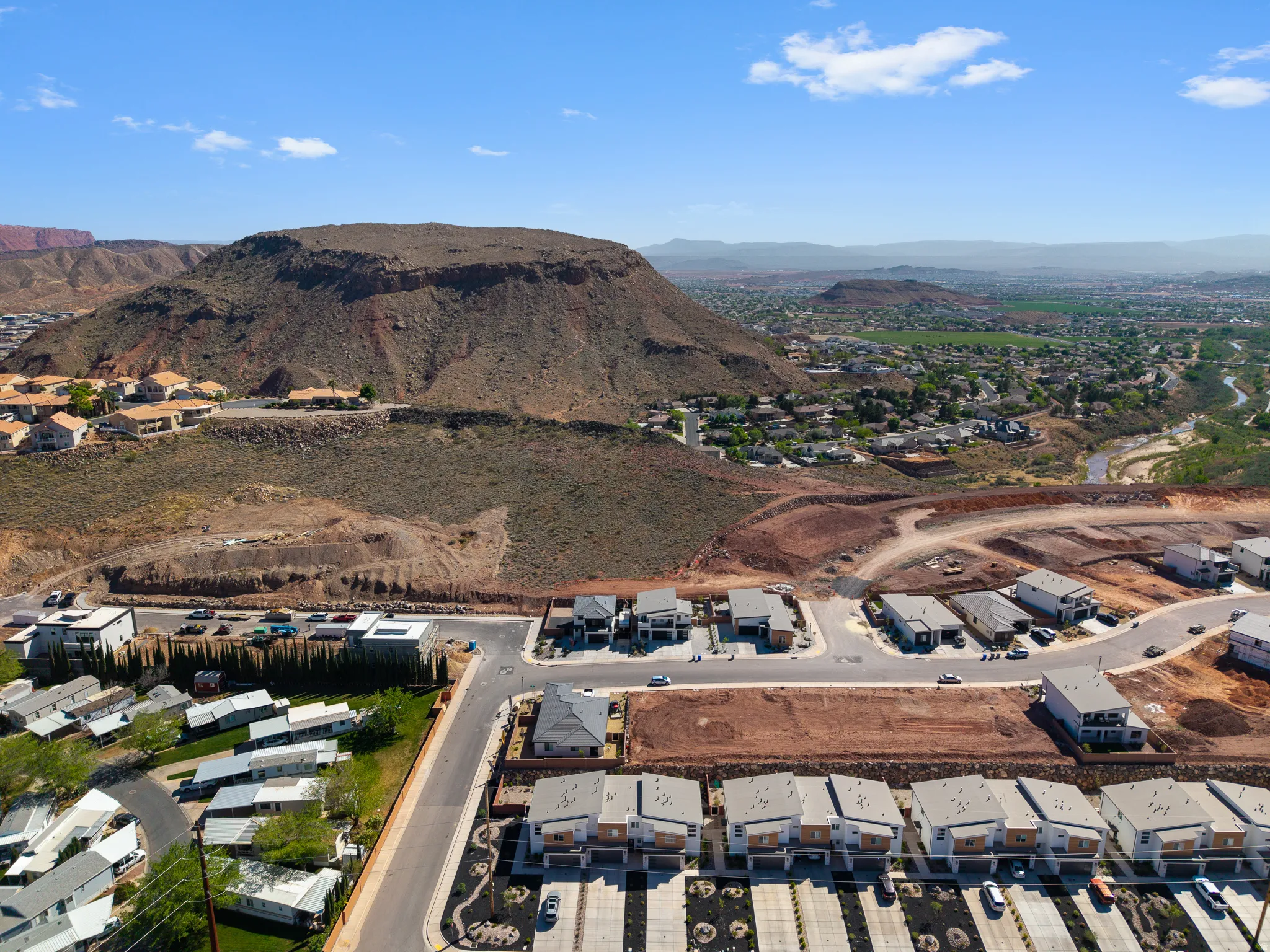 Aerial perspective of suburban area featuring a mountain backdrop