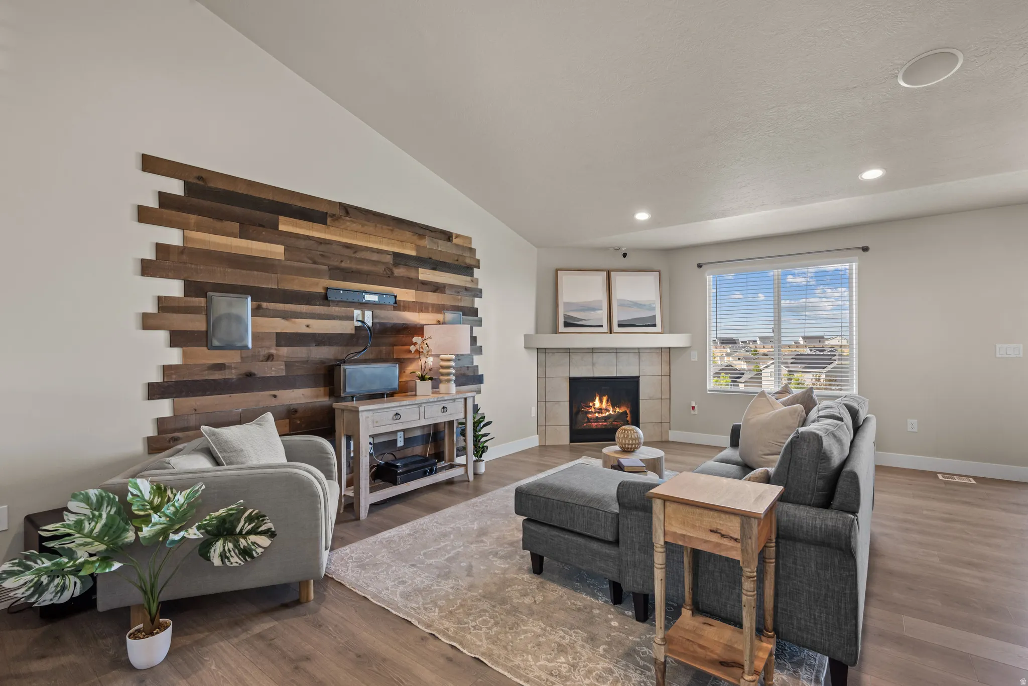 Living area featuring a floor-to-ceiling accent wall with varying wood-finish panels