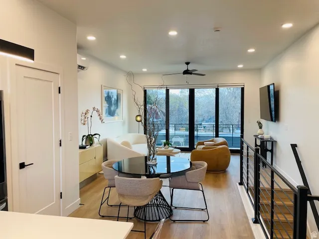 Dining area with light wood-type flooring, ceiling fan, and recessed lighting