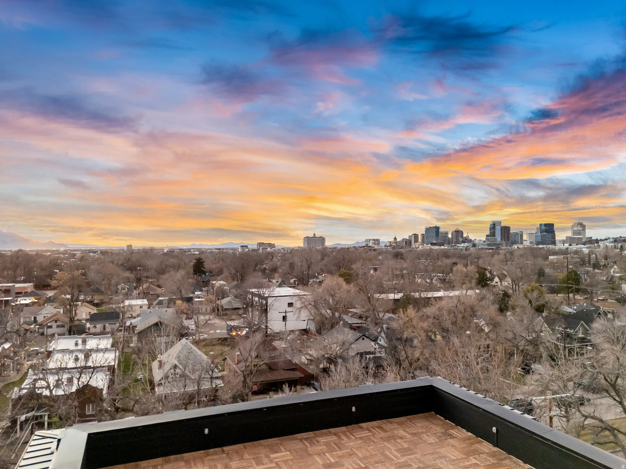 Balcony at dusk featuring a view of skyline