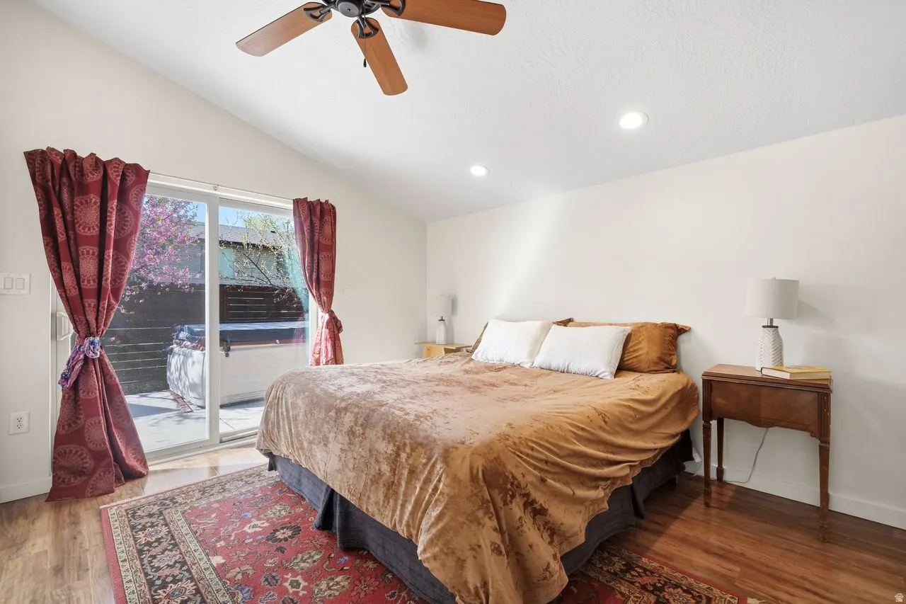Primary Bedroom with access to exterior patio, light wood finished floors, ceiling fan, and recessed lighting