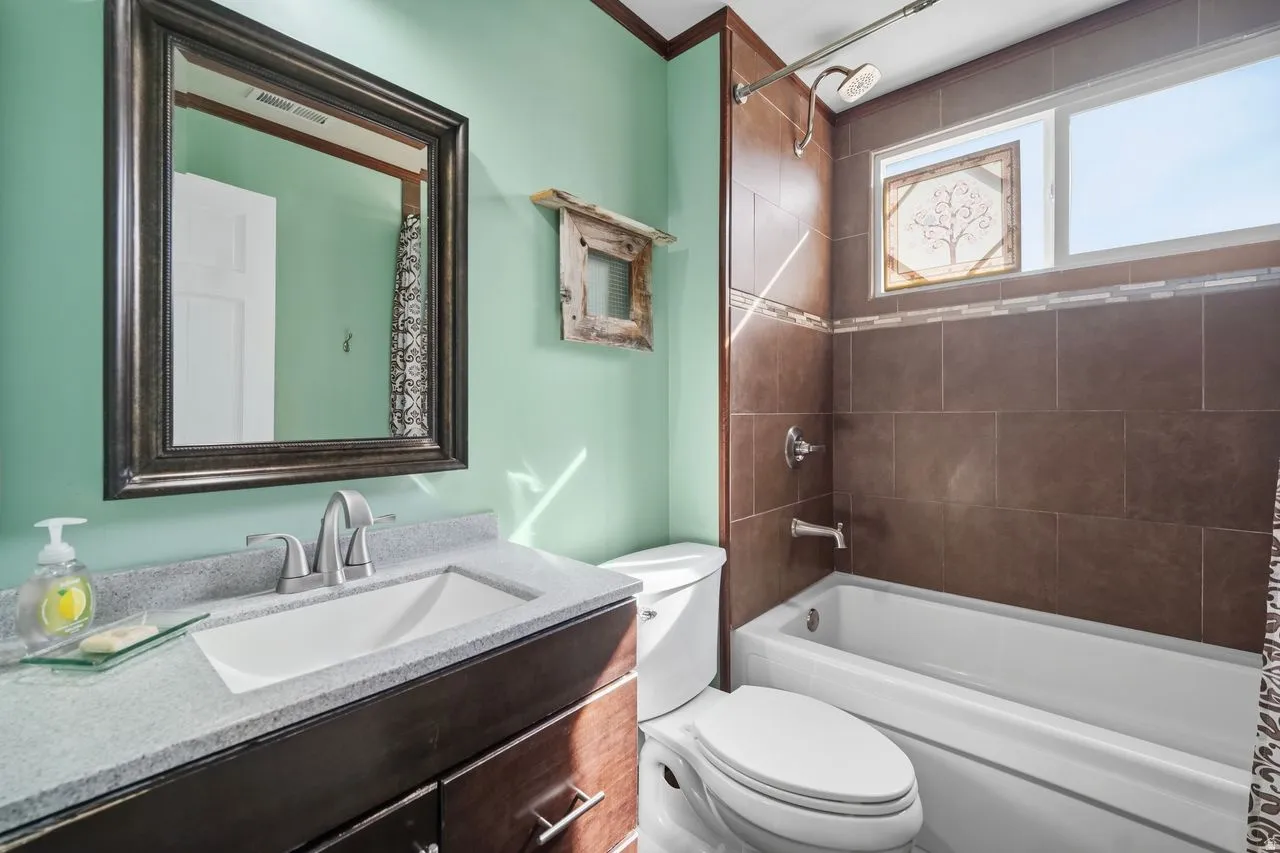 Hall Full Bathroom featuring vanity and shower / bath combo