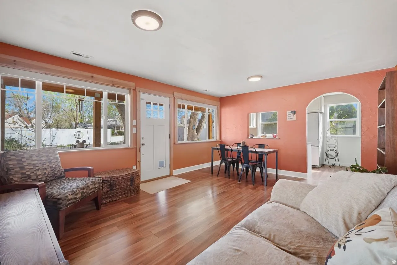 Living area with wood finished floors and arched walkways