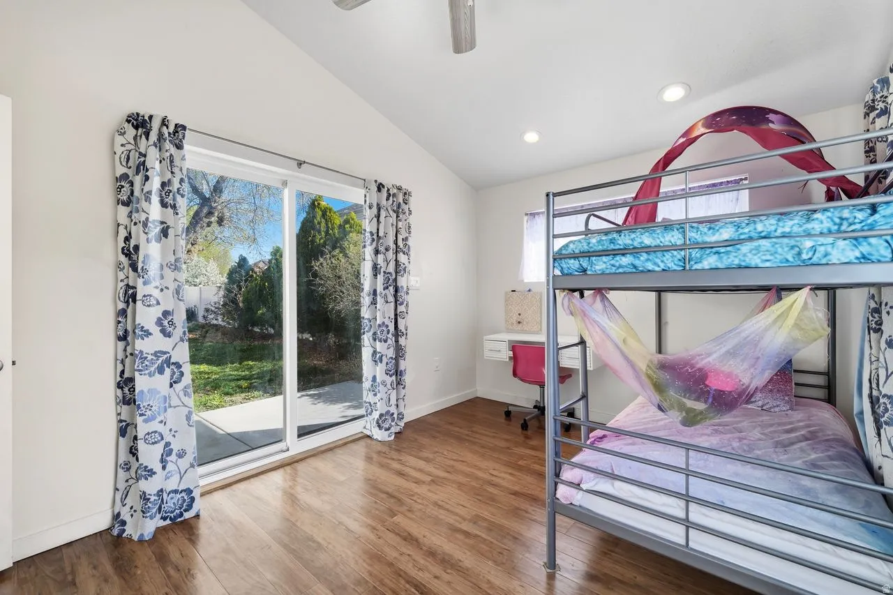 3rd Bedroom with vaulted ceiling, wood finished floors, ceiling fan, access to outside patio, and recessed lighting