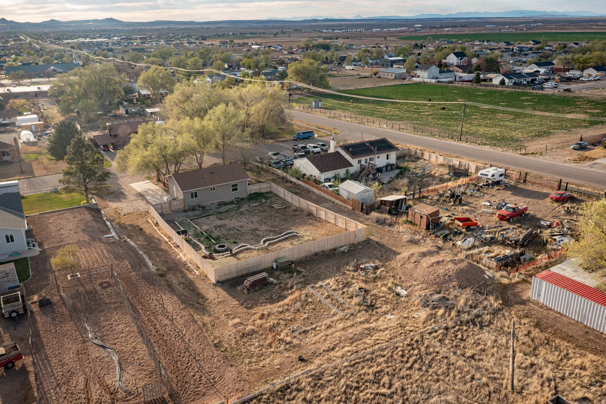 Aerial view of property's location with a mountainous background and nearby suburban area