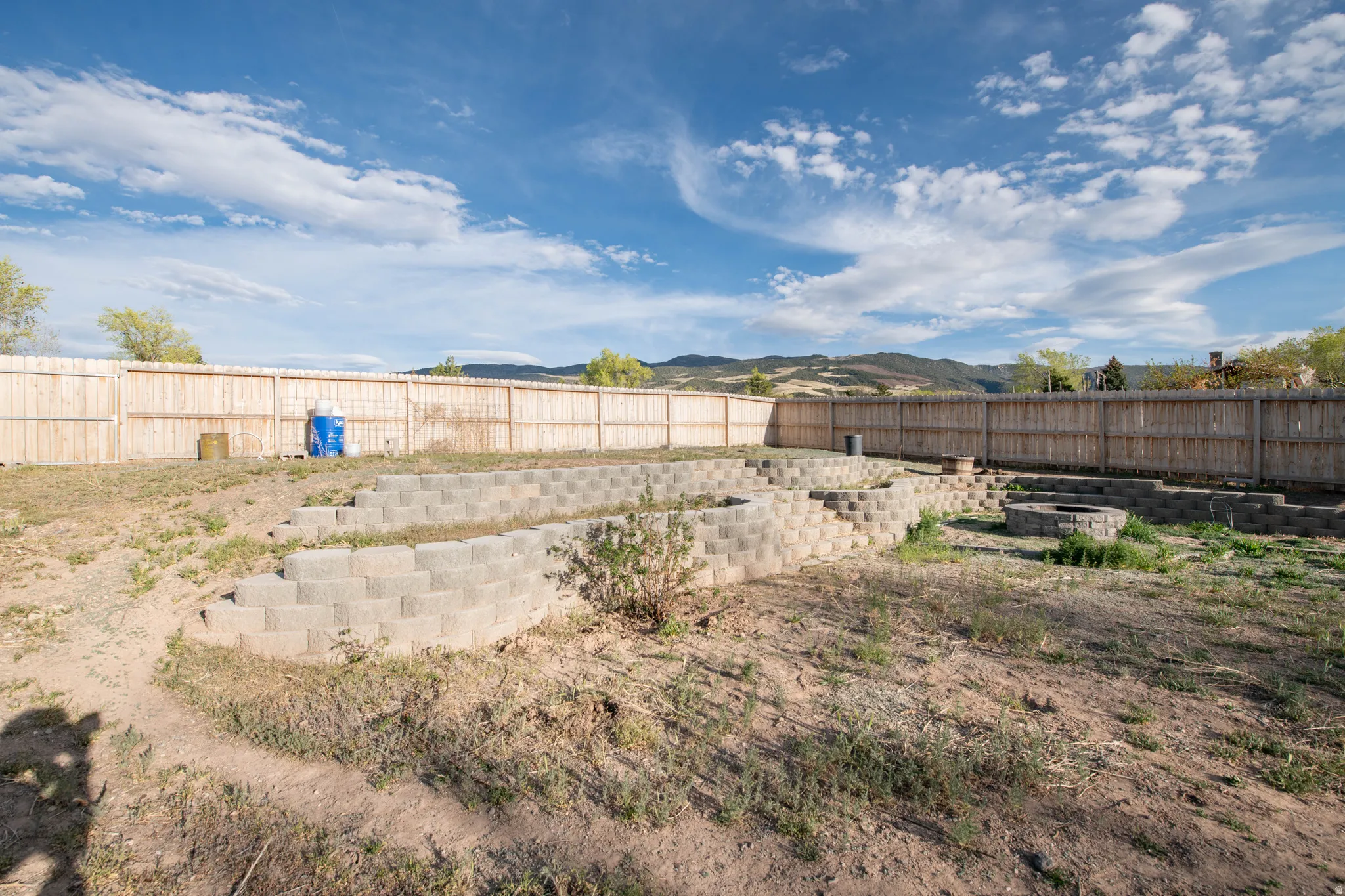 Fenced backyard with a mountain view