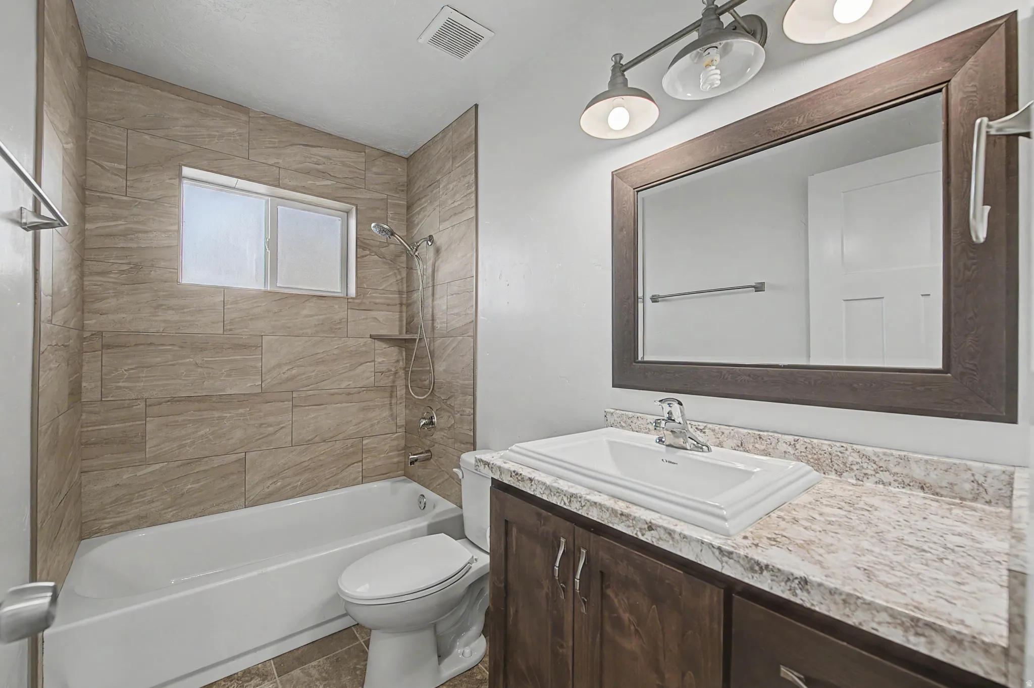 Full bathroom featuring vanity and shower / bath combination