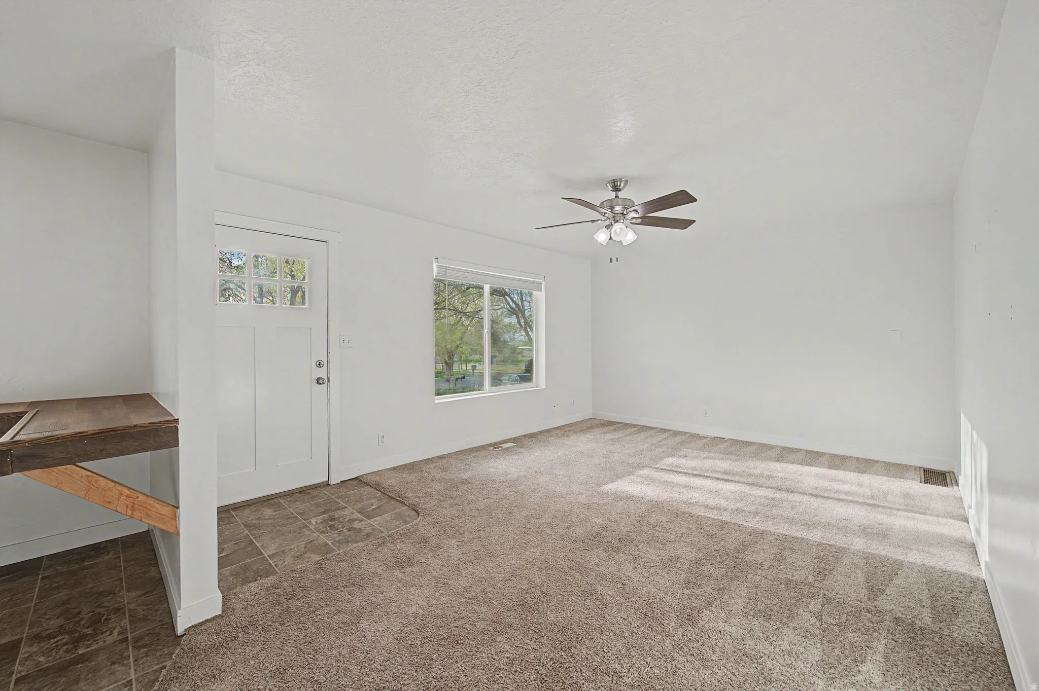 Entryway with carpet and ceiling fan