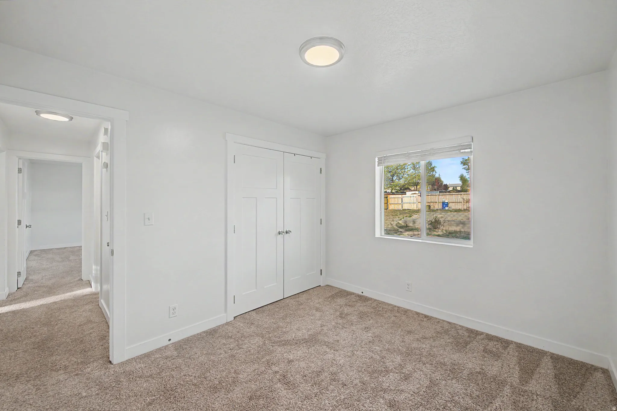 Unfurnished bedroom featuring carpet floors and a closet