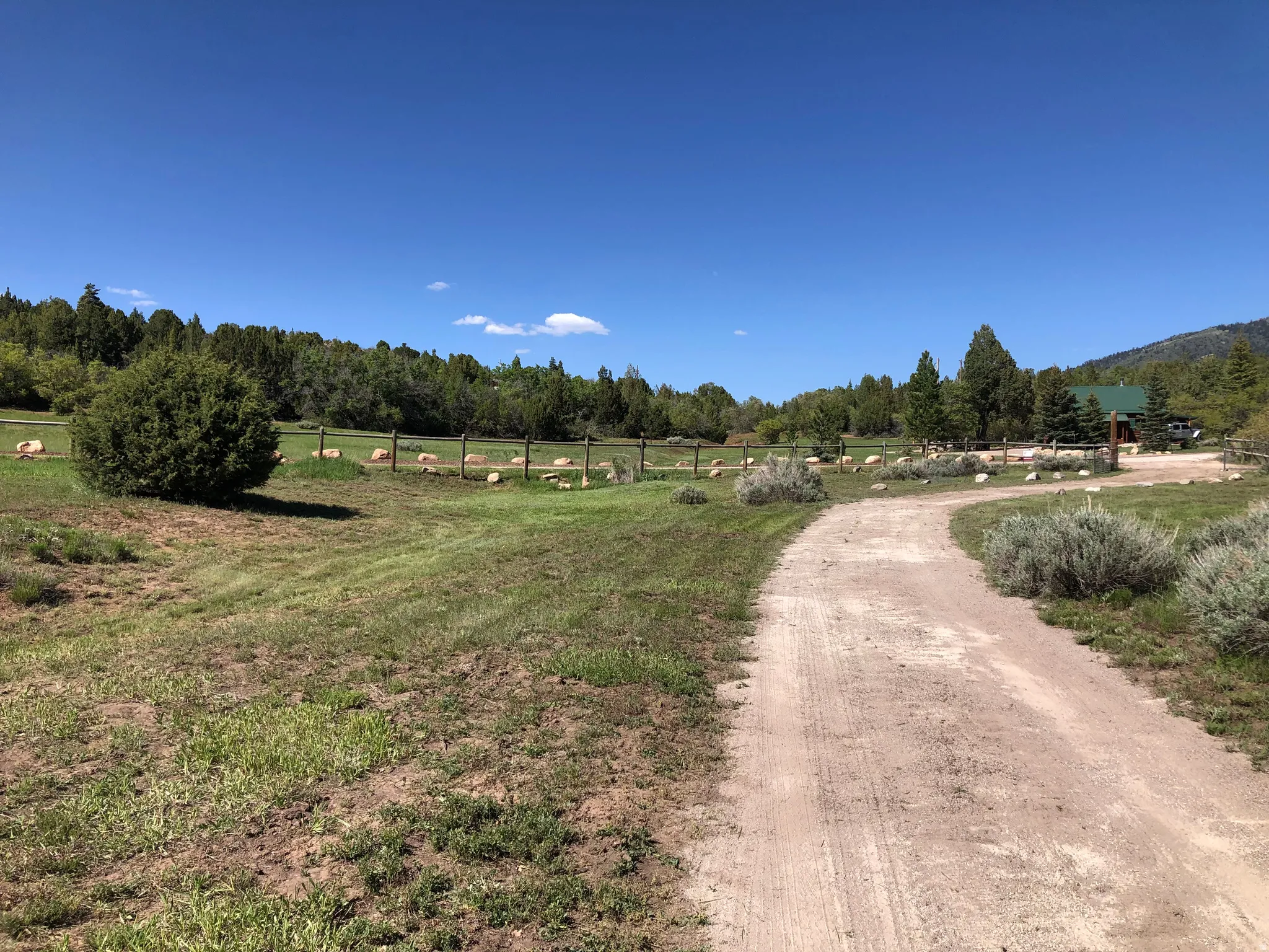 View of dirt / gravel road with a rural view