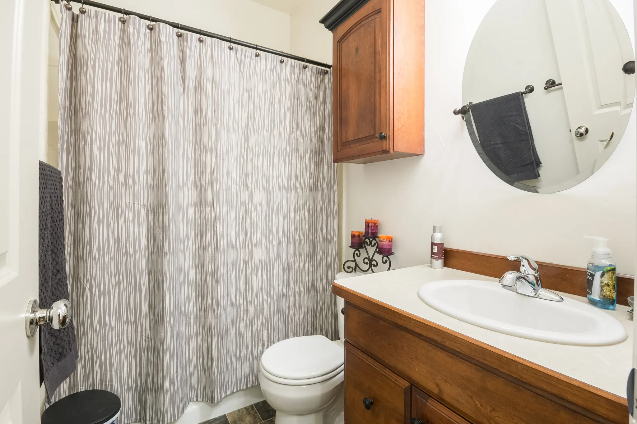 Full bath with a shower with shower curtain and vanity
