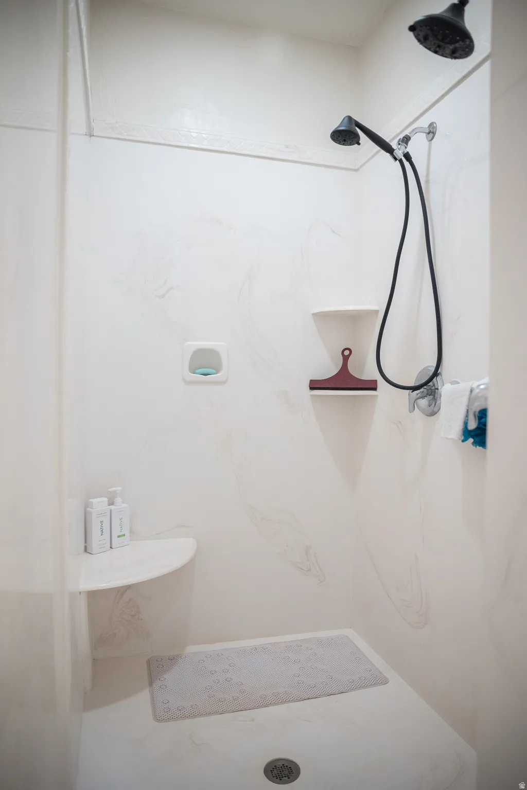 Bathroom featuring a marble finish shower