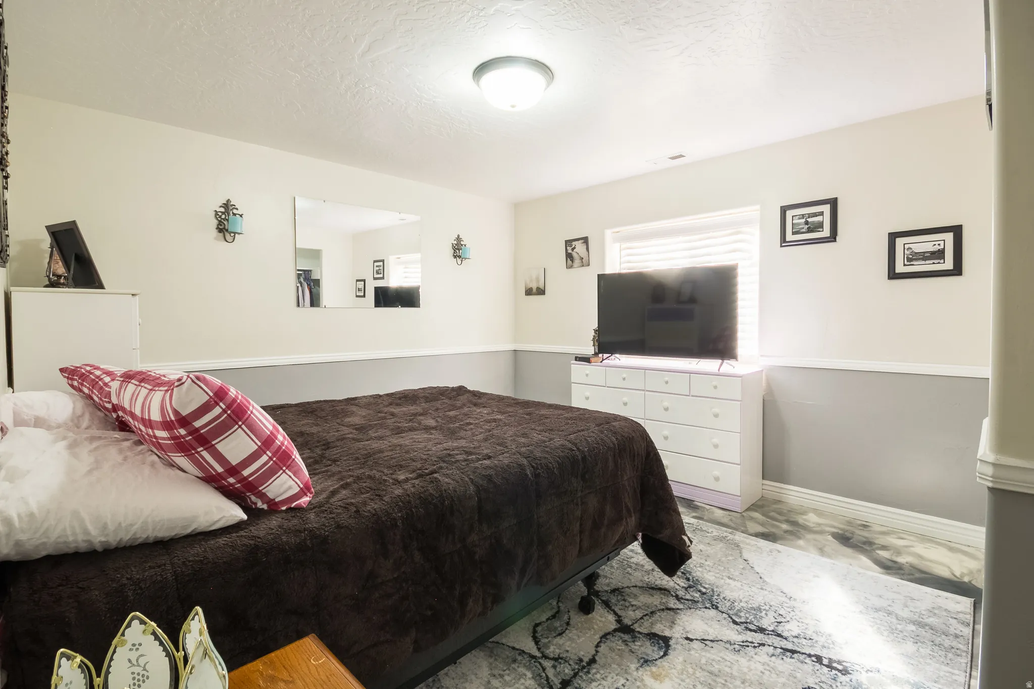 Bedroom with baseboards and a textured ceiling