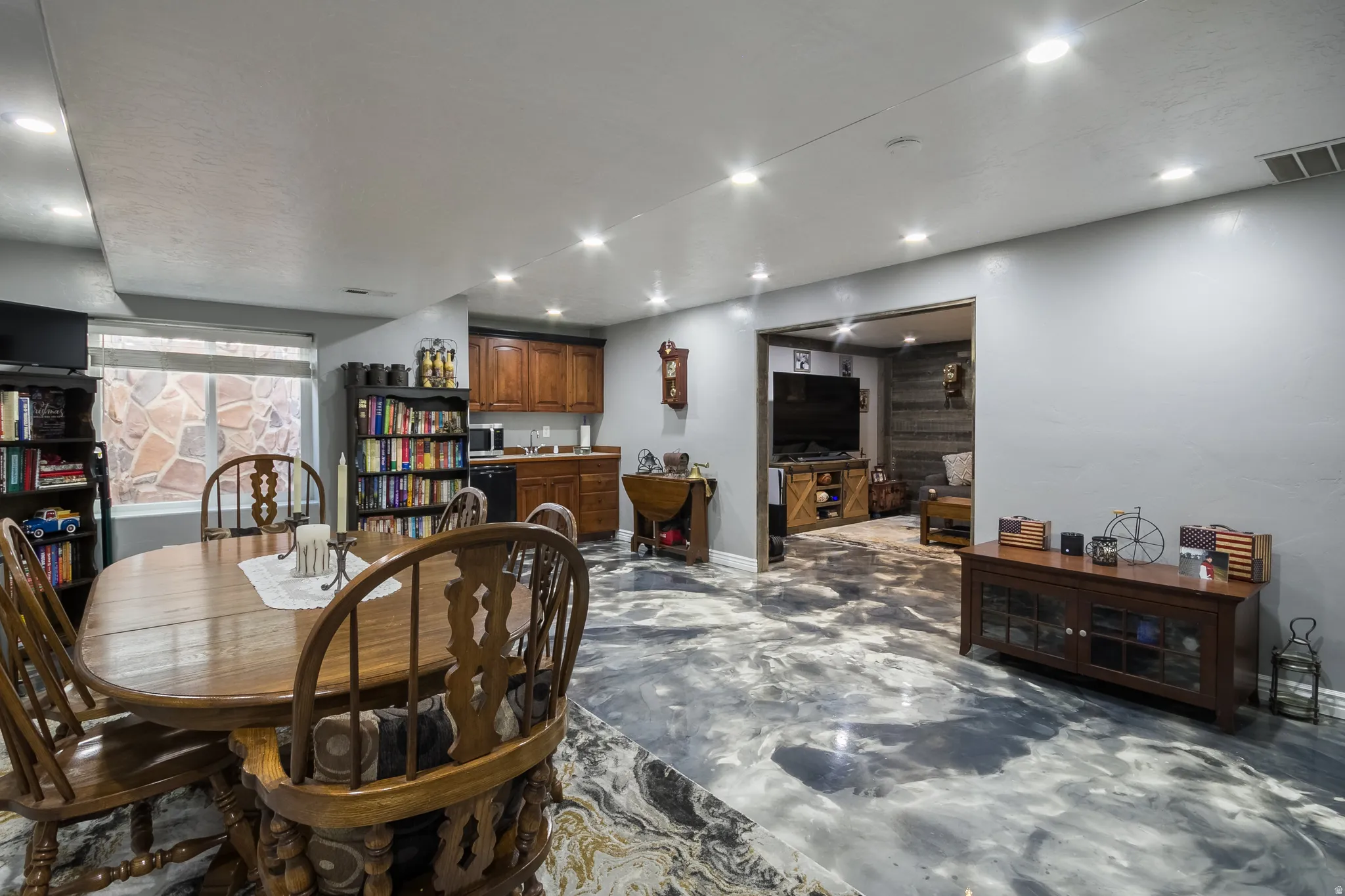Dining room with finished concrete floors and recessed lighting