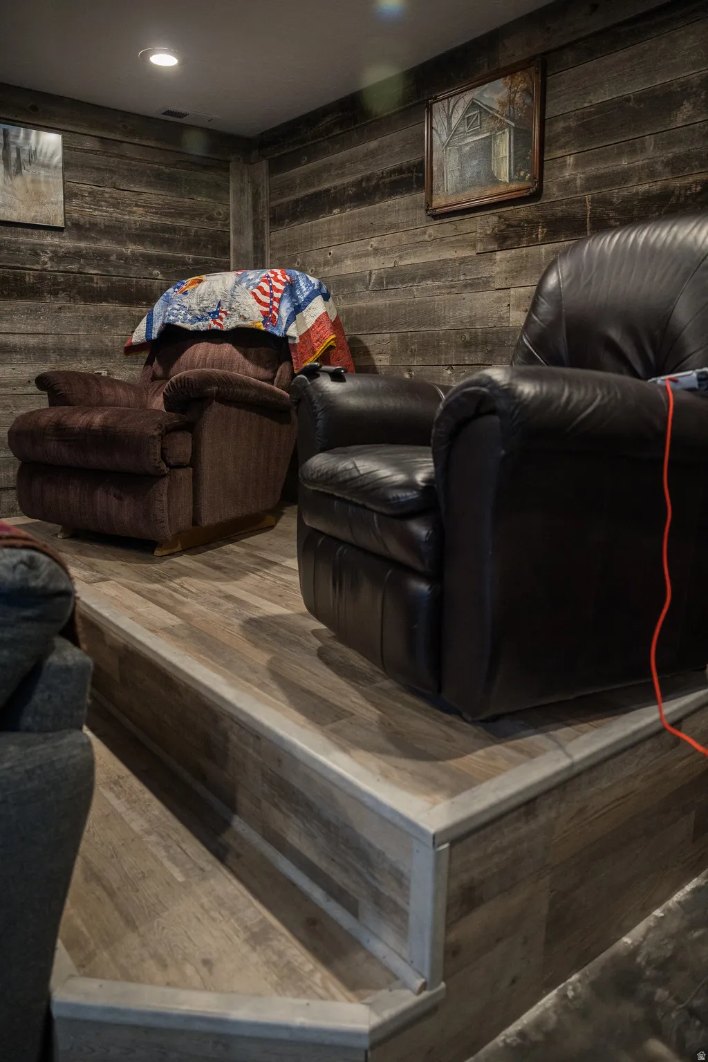 Home theater room featuring wooden walls and recessed lighting