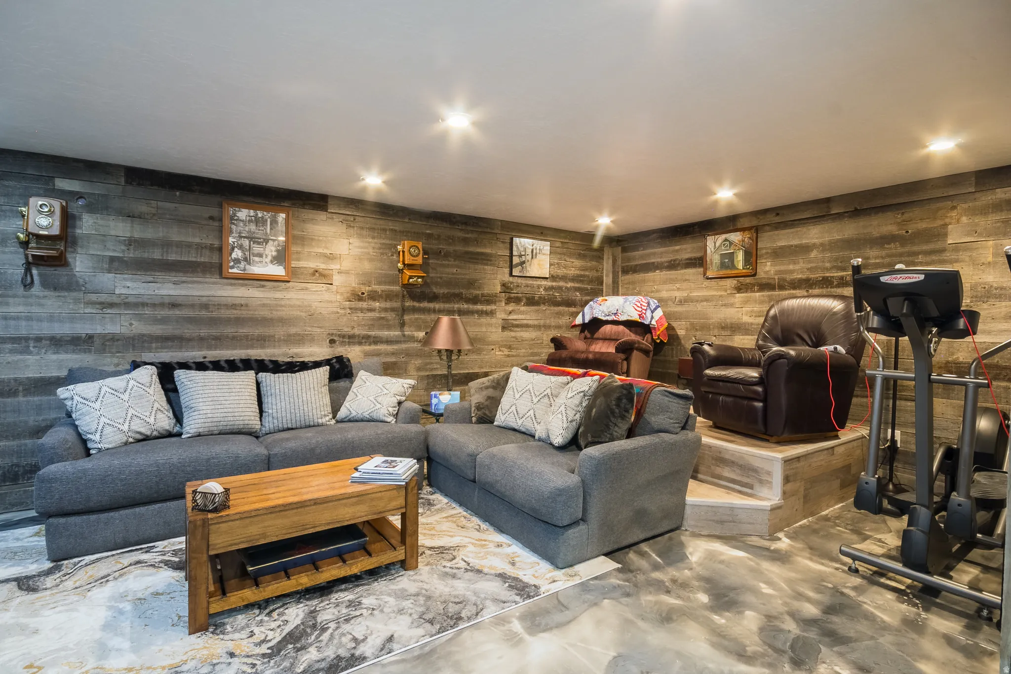 Living area with finished concrete floors and recessed lighting
