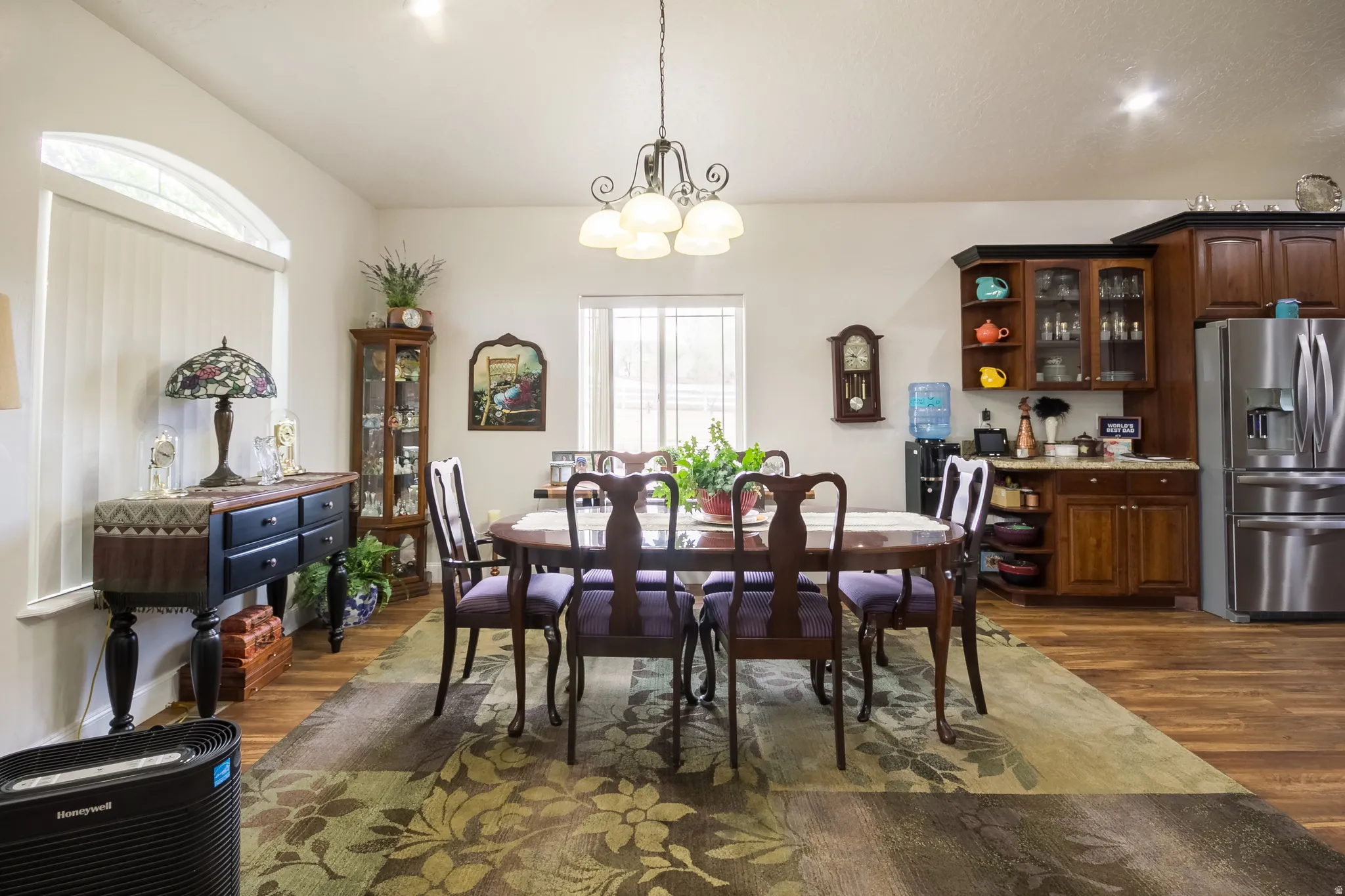 Dining room featuring hanging lights and dark wood finished floors