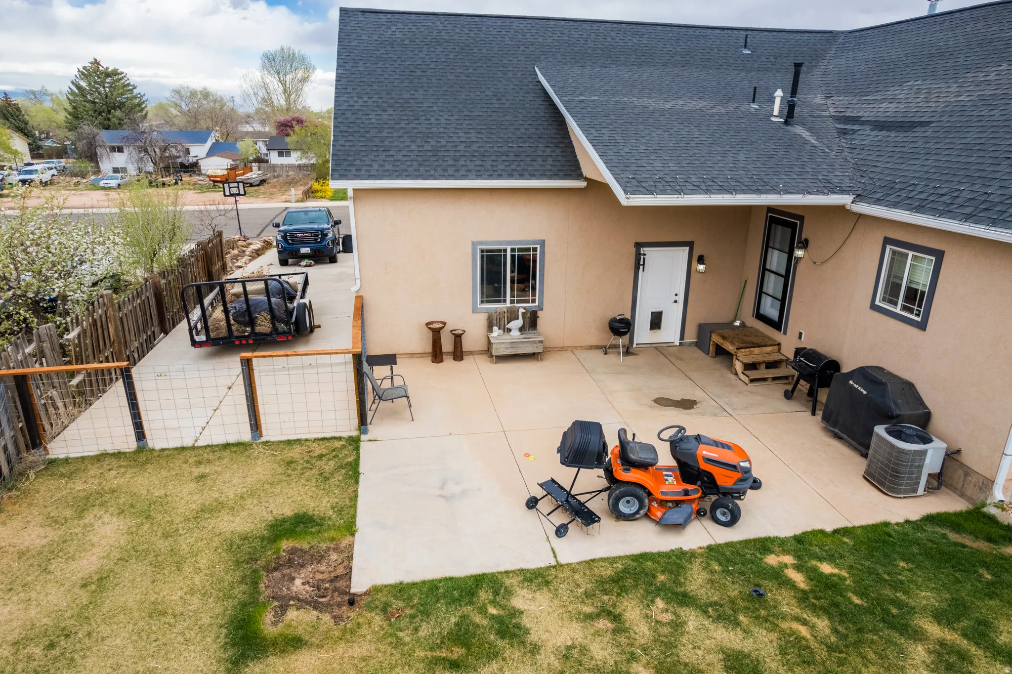 Back of property with stucco siding, roof with shingles, and a patio area