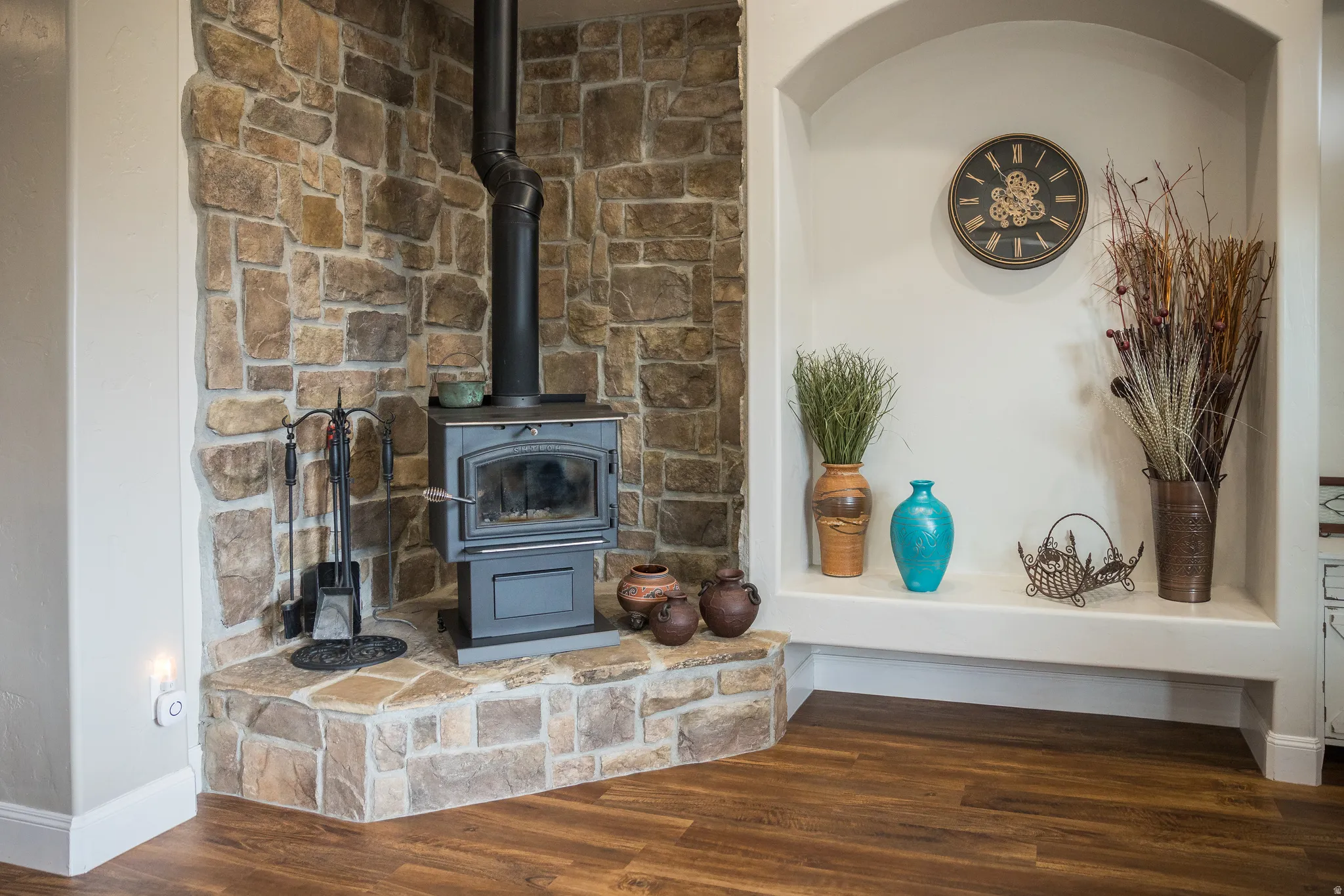 Detailed view of wood finished floors and a wood stove
