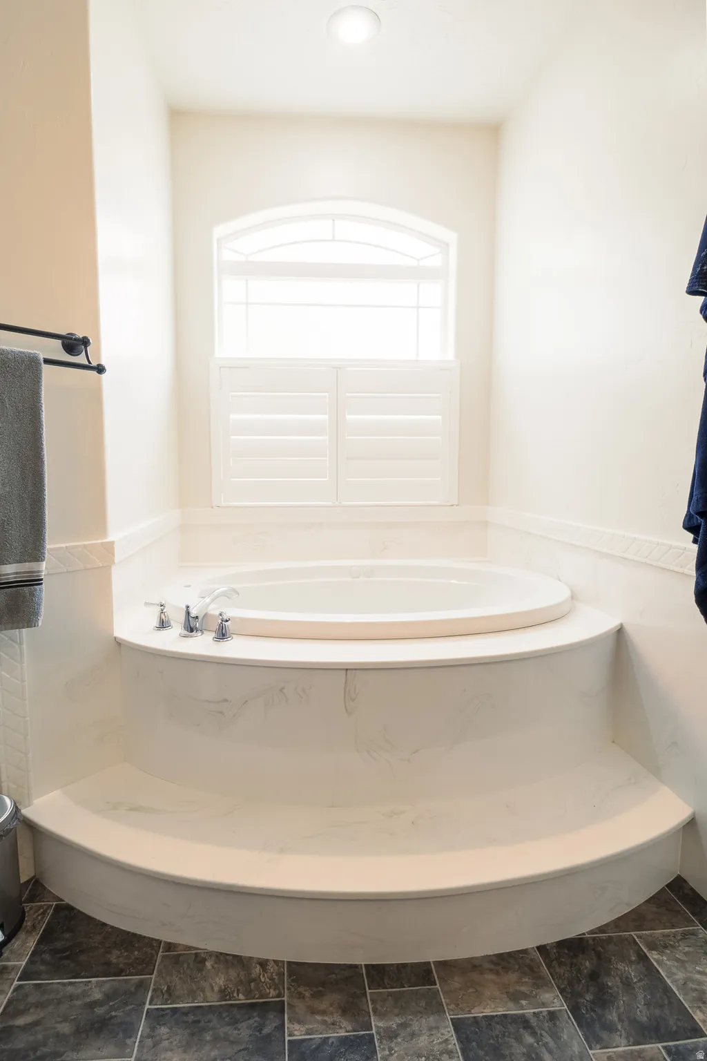 Full bathroom featuring a garden tub and plenty of natural light