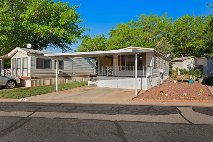 Manufactured / mobile home with an attached carport and concrete driveway