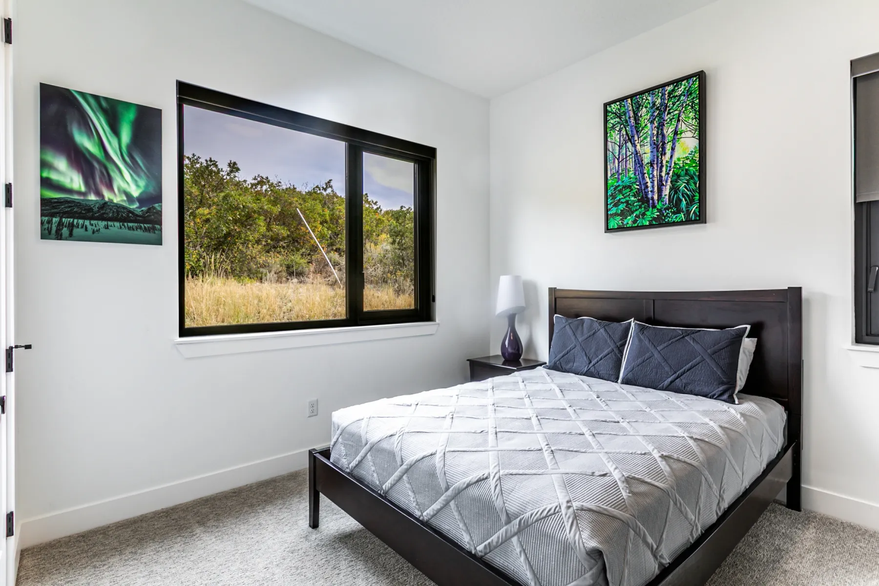 Bedroom with light colored carpet and baseboards