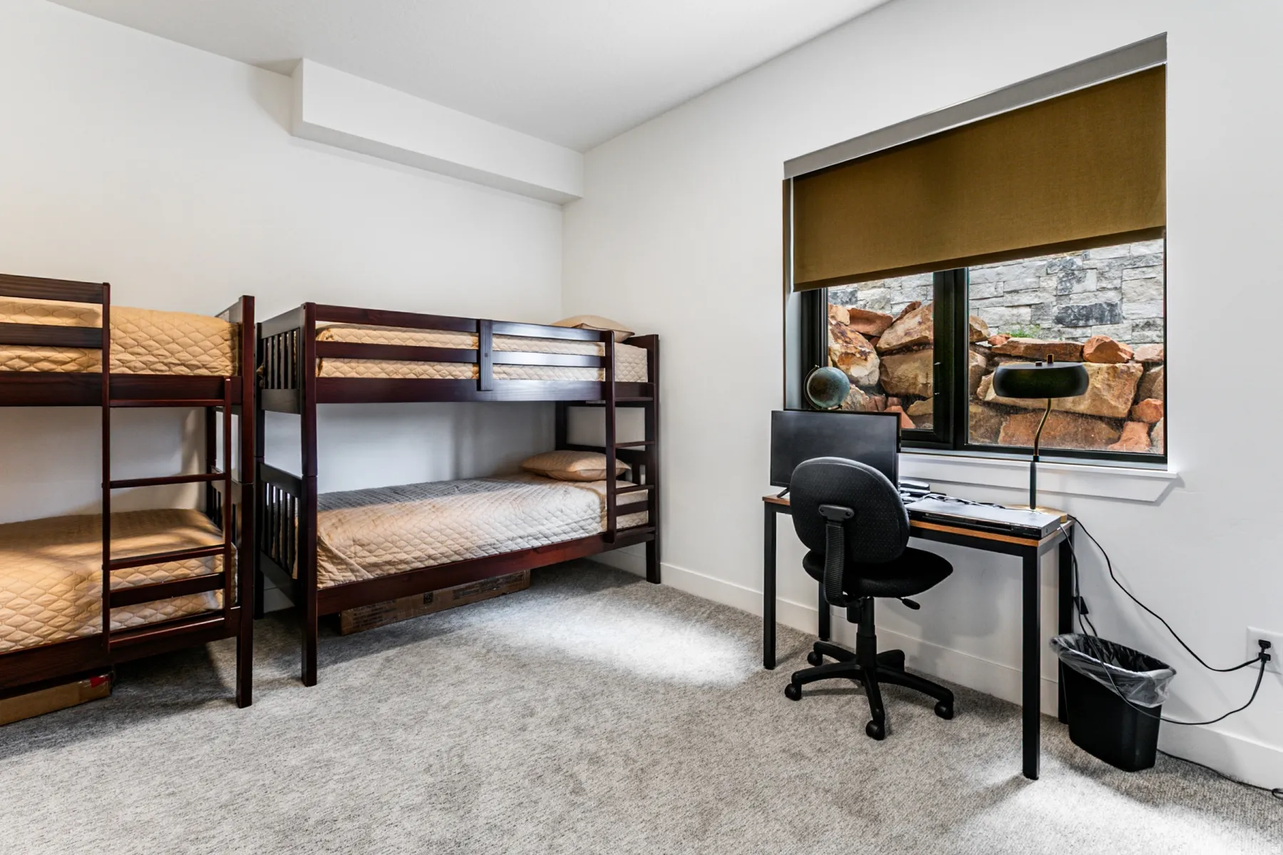 Bedroom featuring light carpet and an office area