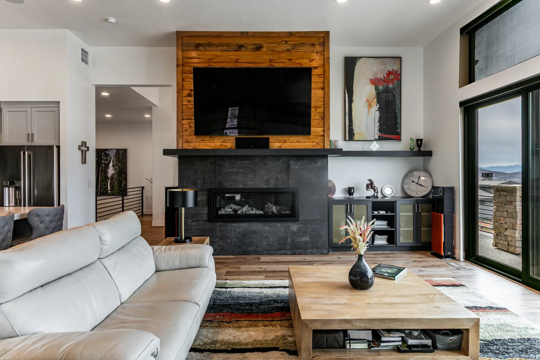 Living area with wood finished floors, a large fireplace, and recessed lighting