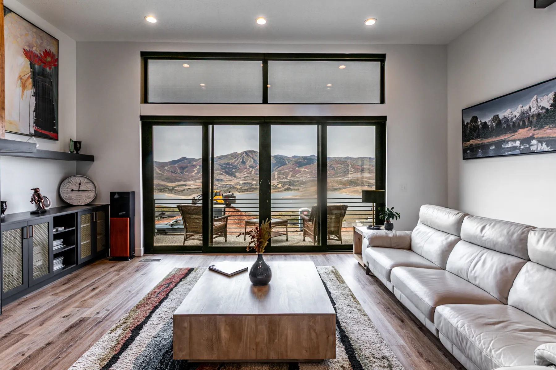 Living room with light wood-style floors, recessed lighting, and a water and mountain view