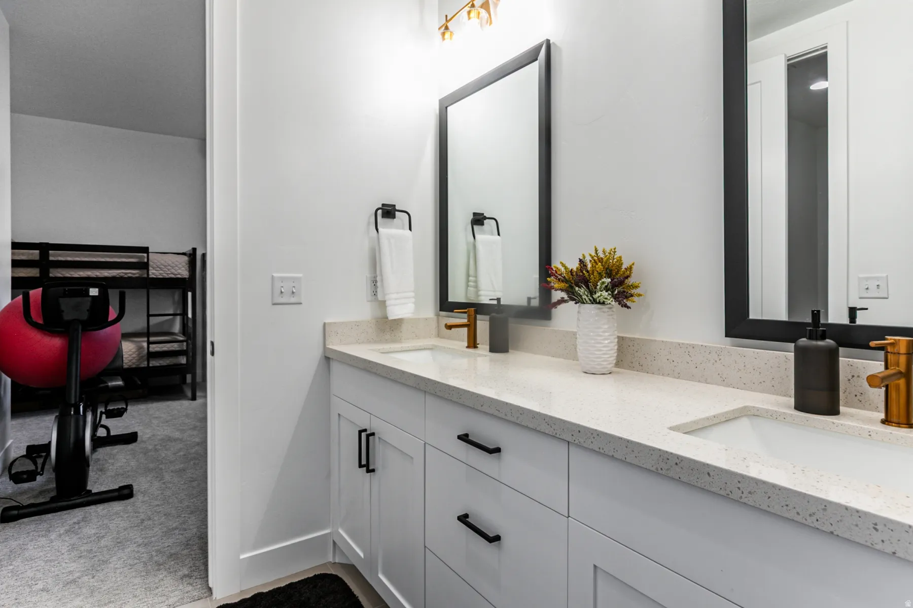 Bathroom featuring double vanity and dark colored carpet