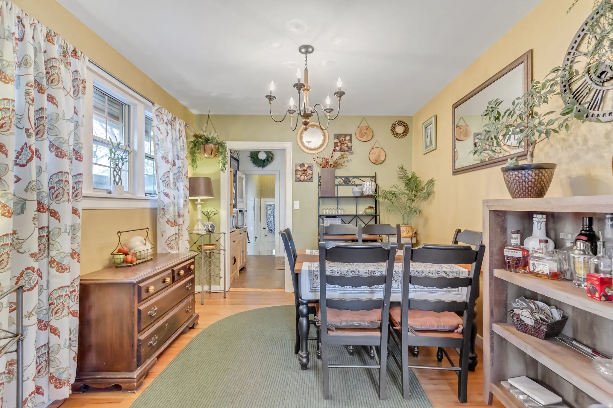 Dining area with light wood-type flooring and a chandelier