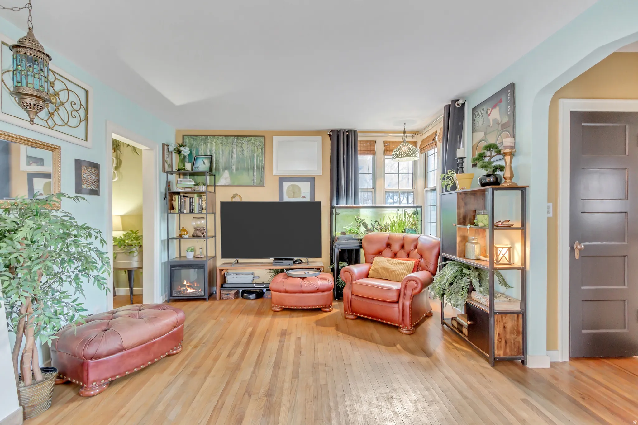 Living area featuring light wood-style floors and arched walkways