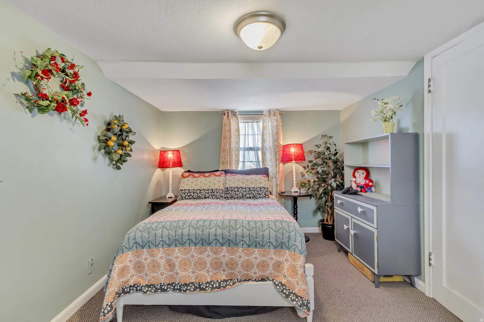 Bedroom featuring light carpet and baseboards