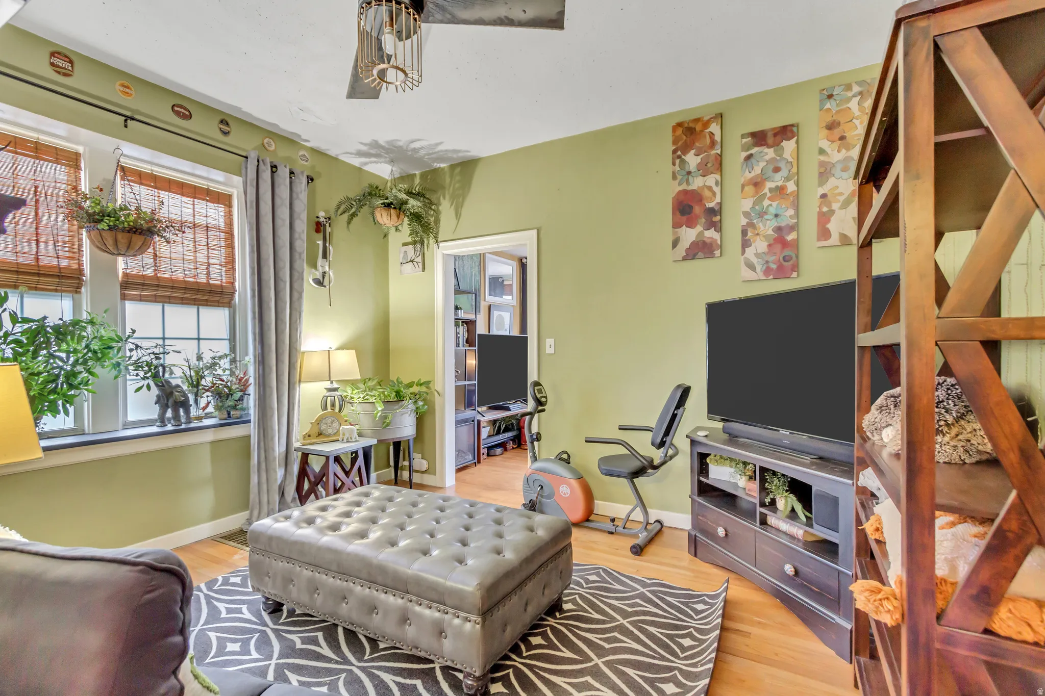 Living room featuring light wood-style flooring and baseboards
