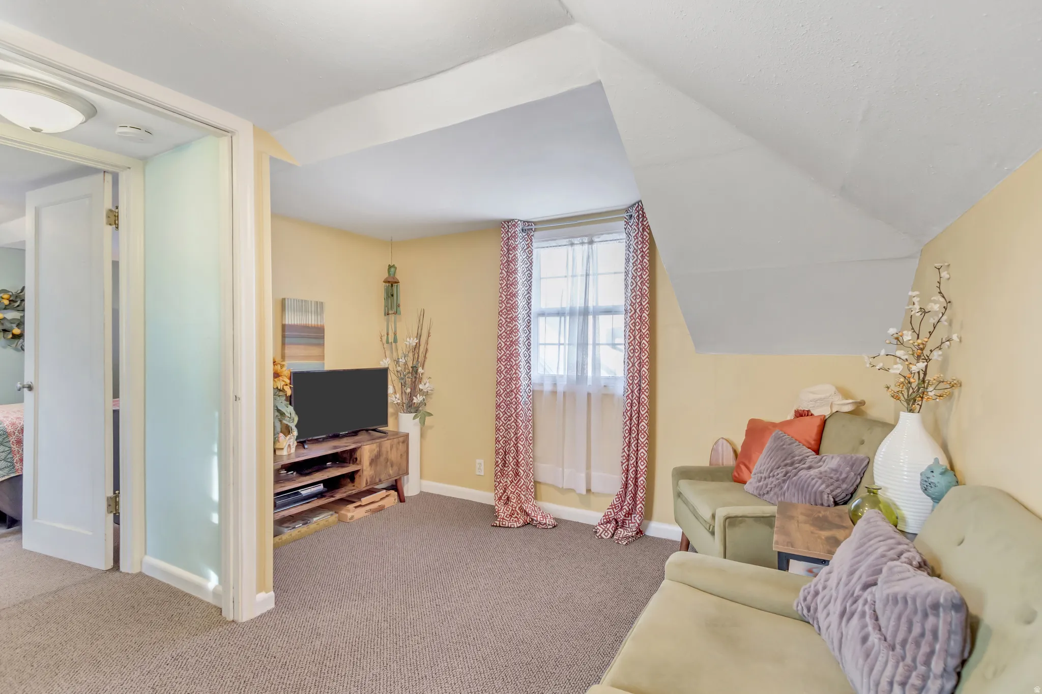 Sitting room with carpet floors and lofted ceiling