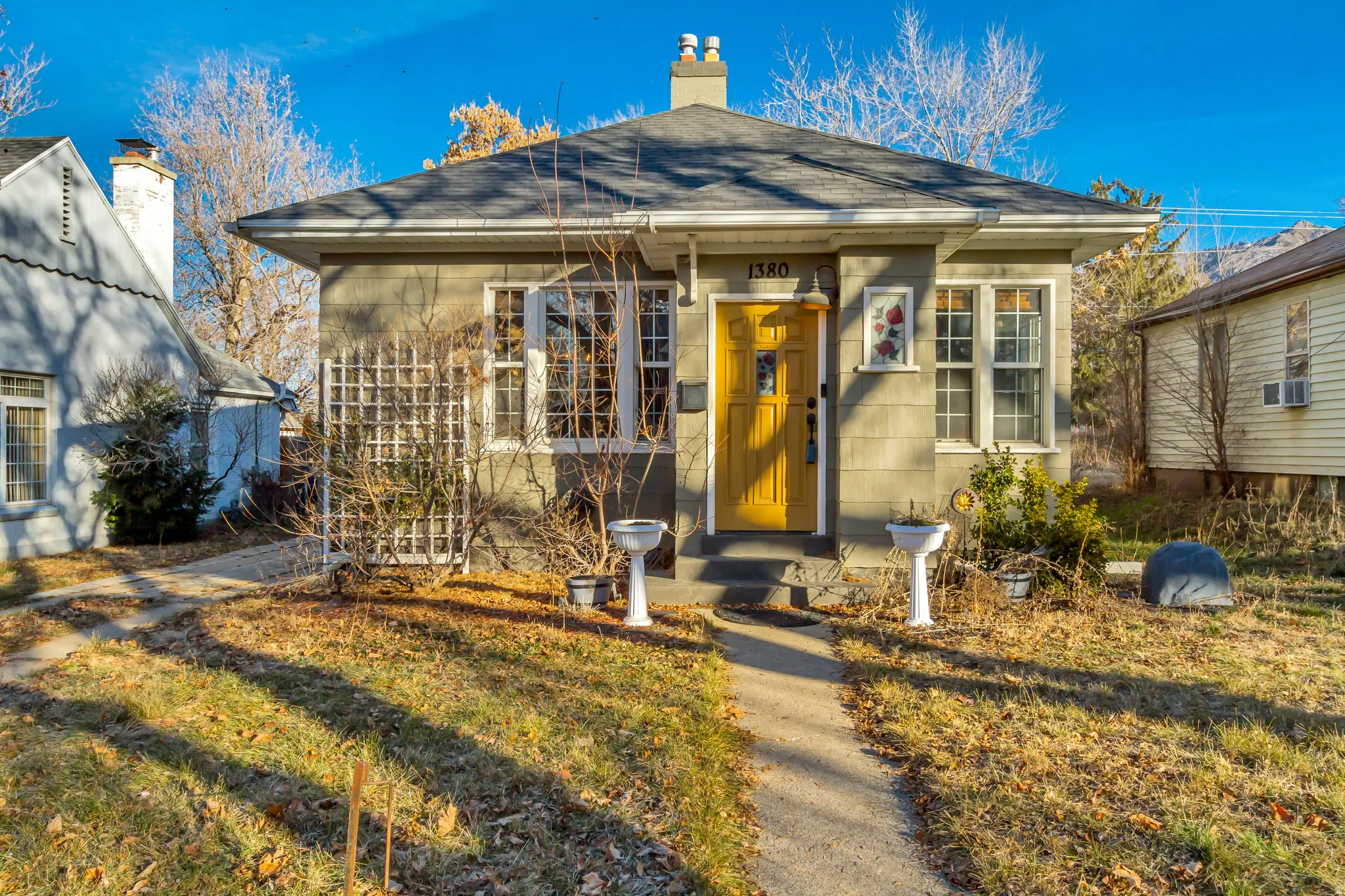 View of front of house with a chimney and a front yard