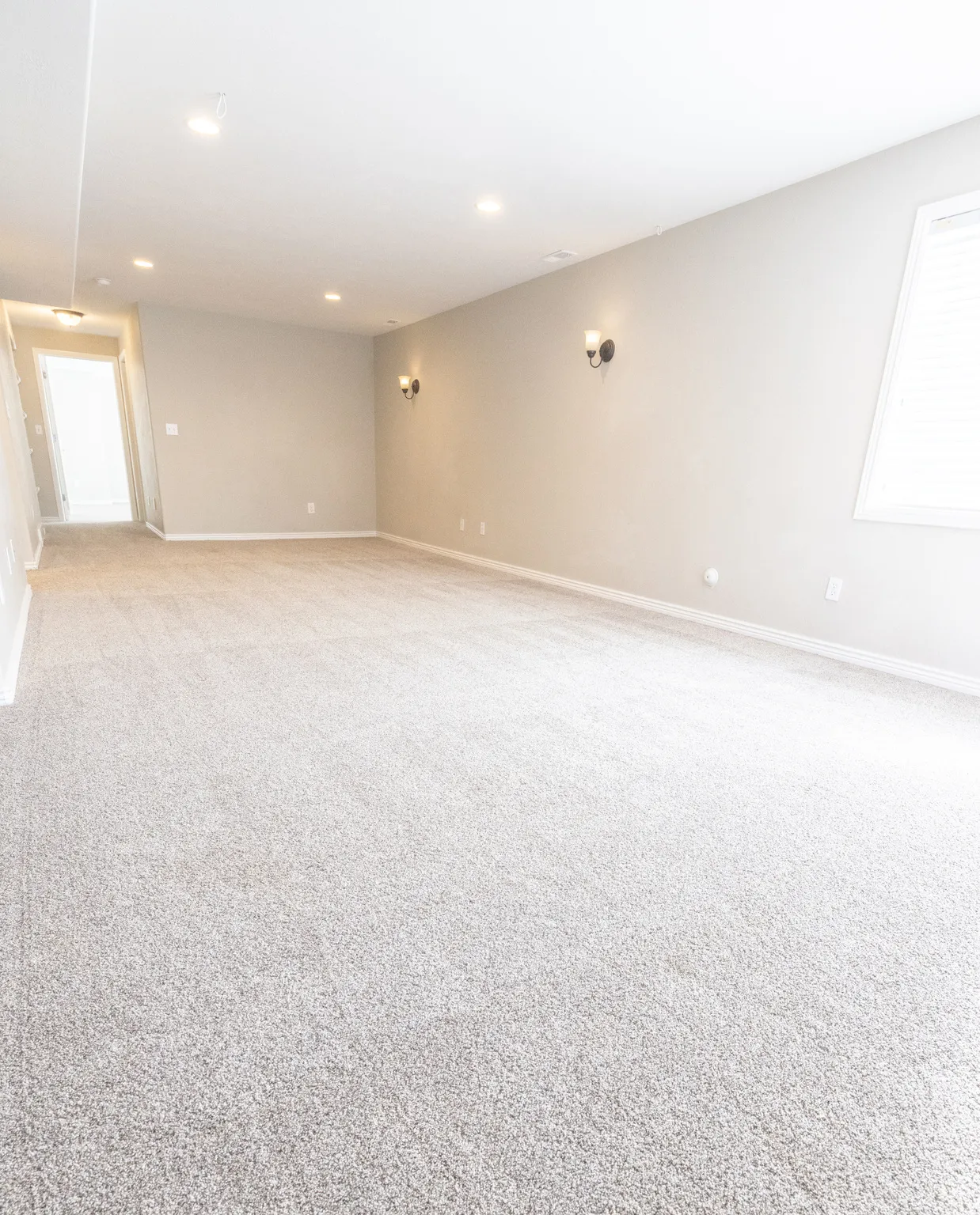 Spare room featuring light colored carpet and recessed lighting