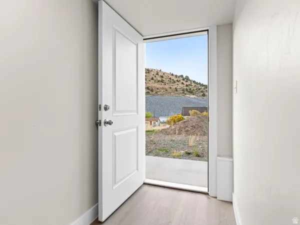Entryway with wood finished floors and baseboards