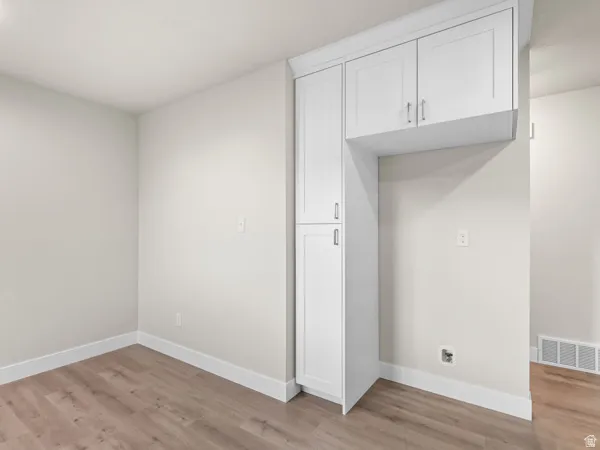 Spare room featuring baseboards and light wood-style floors
